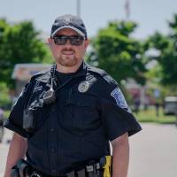 A GVPD officer and his dog smiling for a photo.